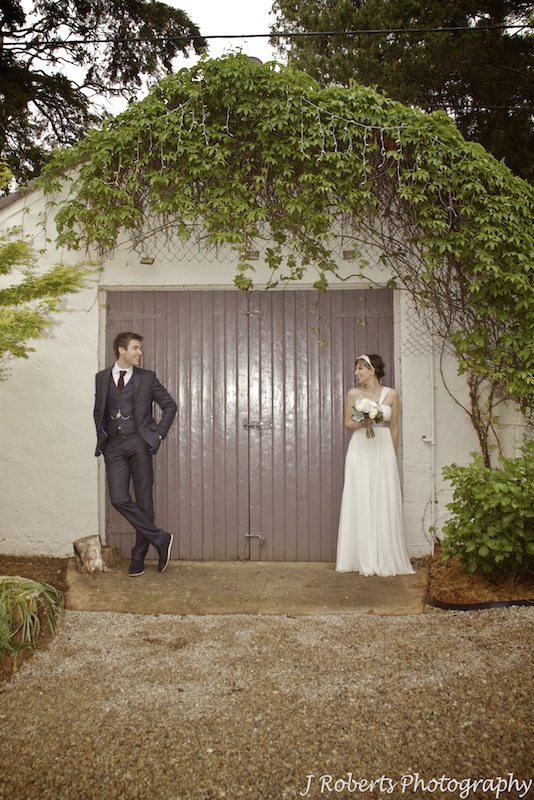 Bride and groom outside barn - wedding photography